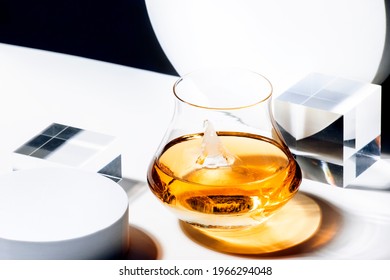 Whiskey, Scotch Or Bourbon Glass With Ice On Black And White Background With Geometric Cubes And Circles. Contemporary Still Life 