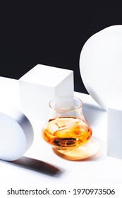 Whiskey, Scotch Or Bourbon Glass With Ice On Black And White Background With Geometric Cubes And Circles. Contemporary Still Life 