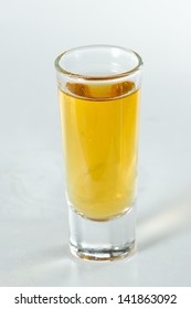 Whiskey Served In A Tall Shot Glass Isolated On A White Background