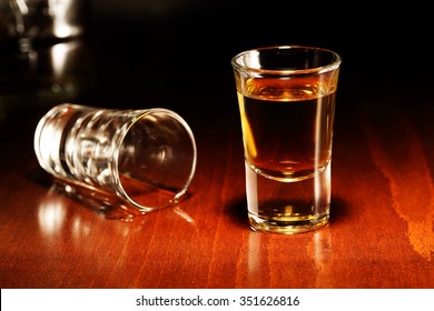 Whiskey Shots On Wooden Surface