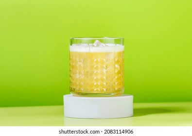 Whiskey Sour Popular Alcoholic Cocktail With Bourbon, Lemon Juice, Egg White And Ice, Rocks Glass On Bright Green Background