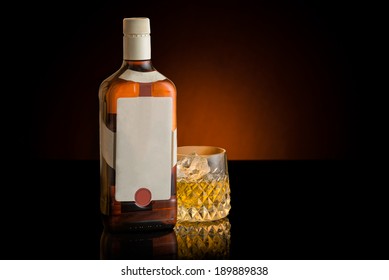 Whisky Bottle And Glass With Copy Space. White Blank Label. Orange Background. Whiskey.