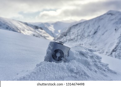 Whisky Flask In The Snow Of Mountains In Nevis Range, Scotland.