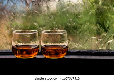 Whisky In A Glass And Blurred Background.