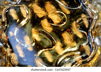 Whisky Glistening On The Bottom Of A Glass Resting On A Funky Carpet