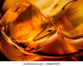 Whisky on the rocks, glass filled with ice cubes, close-up shot - Shutterstock ID 2180607095