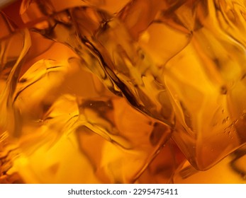 Whisky on the rocks, glass filled with ice cubes, close-up shot