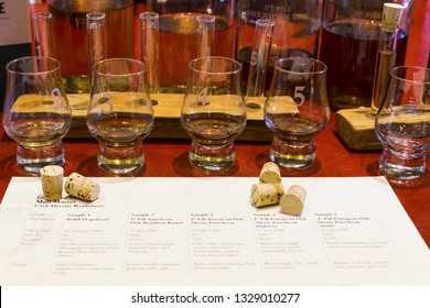 Whisky Tasting Setup With Numbered Sampling Glasses, Beaker And Bottles On Display.