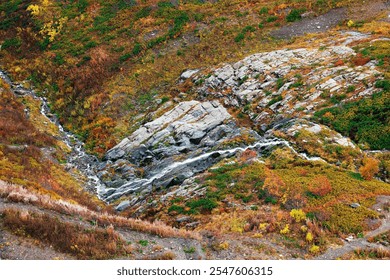 Whispers of Autumn A Serene Stream Flowing Through Vibrant Rocky Terrain! - Powered by Shutterstock