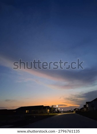 Whispy rainbow cloud at sunset