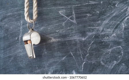 Whistle of a soccer coach or referee on black board with free copy space - Shutterstock ID 1067770652