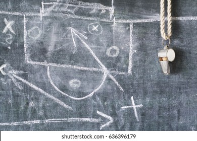 whistle of a soccer or football trainer or referee on black board with tactical diagram 