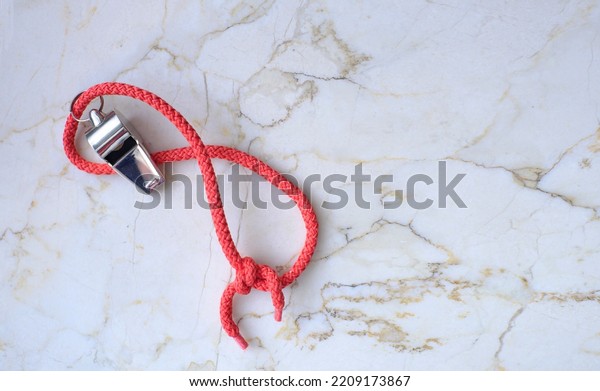 Whistle of\
soccer referee or coach flat lay on marble  background. Great\
soccer event this year, large free copy\
space