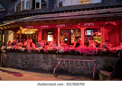 Whistler BC, Canada - July 30, 2021:  Tourists On The Patio Of A Local Whistler Restaurant On A Warm Summer Night.  