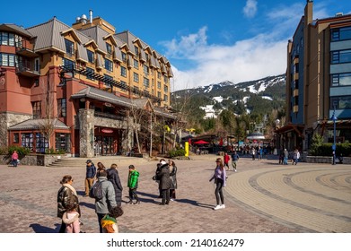 The Whistler Village on a spring day with skiers on Whistler Mountain.  