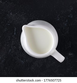 
Whit Milk Jug With Milk On A Black Background, Top View.