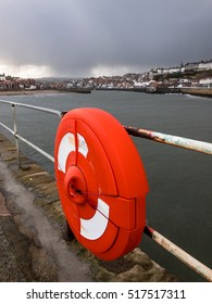 WHITBY, ENGLAND - NOVEMBER 5: Life Preserver Ring And A Storm Approaching, Whitby. In Whitby, North Yorkshire, England. On 5th November 2016.