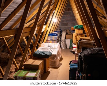 Whitchurch, Shropshire, UK – 8 9 2020:  Loftspace in the roof of a family home, is a favourite storage place for cases, boxes and domestic treasures.