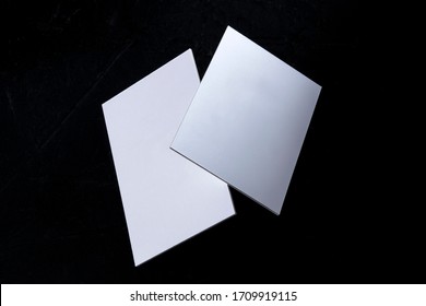 White 3 ply business cards, floating on a black background, a mock-up - Powered by Shutterstock