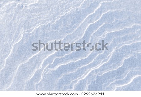 White abstract natural blurred background of snowy ice sea surface on cold winter day. Frozen snow waves texture. Wmpty space for text. Top view, flat lay, copy space, mock up, blank