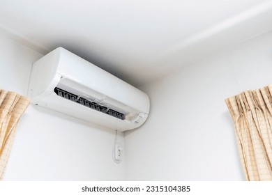 White air conditioner on the wall of the room - Shutterstock ID 2315104385