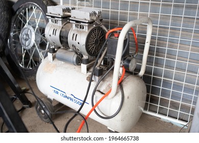 white air pump compressor in garage