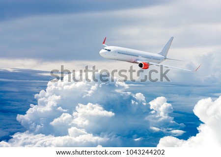 White airplane flying above cloud