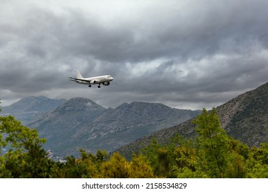 White airplane landing in Dubrovnik airport (Cavtat). - Shutterstock ID 2158534829