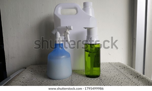 White alcohol gallon Divided into small green\
bottles and blue sprays