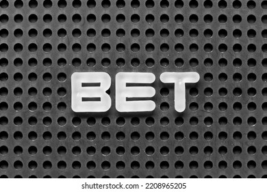 White Alphabet Letter In Word Bet On Black Pegboard Background