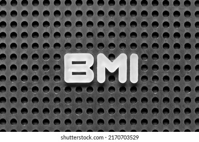 White Alphabet Letter In Word BMI (abbreviation Of Body Mass Index) On Black Pegboard Background