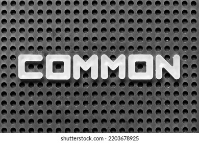 White alphabet letter in word common on black pegboard background - Shutterstock ID 2203678925