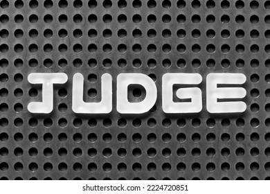 White Alphabet Letter In Word Judge On Black Pegboard Background