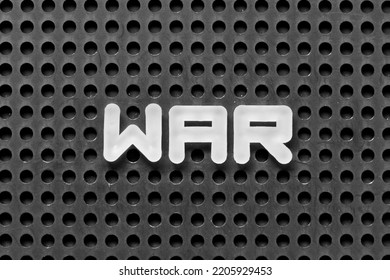 White Alphabet Letter In Word War On Black Pegboard Background