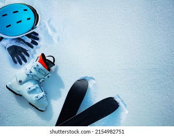 White alpine ski boot helmet and gloves in snow view from above - winter mountains vacation concept