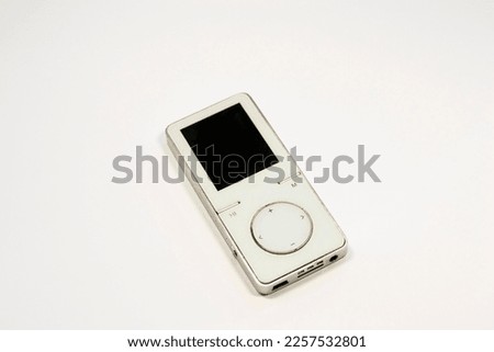 White Aluminum MP3 Player. Listening to music
