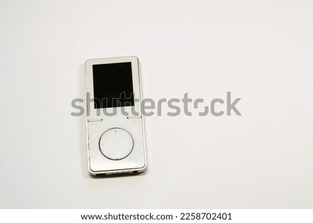 White Aluminum MP3 Player. Listening to music