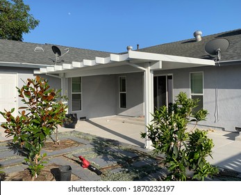 White Aluminum Patio Cover Attached To California Home.