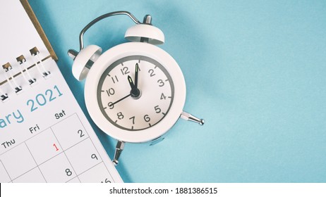 White Analog Clock And 2021 Calendar On Grunge Blue Background With Copy Space, Business Meeting Schedule, Travel Planning Or Project Milestone And Reminder ,New Year Holiday , Celebration Concept