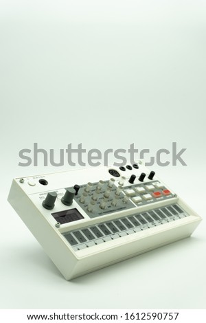 White analog synthesizer sampler with knobs and keys. Audio equipment for musical production. Drum machine. Isolated on white background. Music concept.