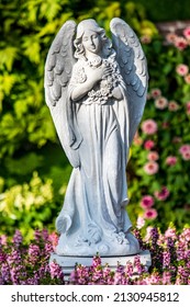 White Angel Statue In The Public Park English Flowers Garden Park Style.