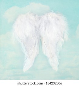 White Angel Wings On Textured Blue Sky Background