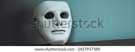 White anonymous mask on the table
