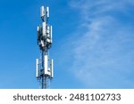 White antennas on cell tower close-up. Mobile data transmission tower with antennas against a blue clear sky, concept of telecommunications equipment, Future 6G high-speed mobile.