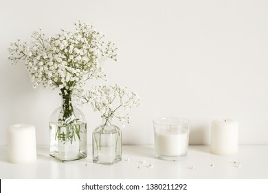 White arrangement of baby's breath flowers and candles. Copy space for lettering - Powered by Shutterstock