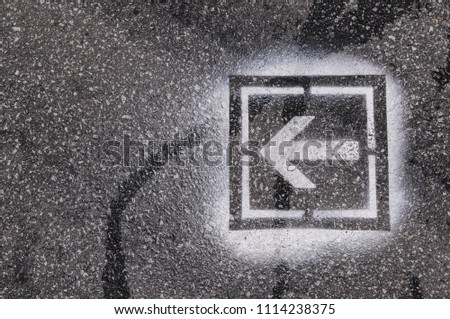 white arrow pointer on the asphalt