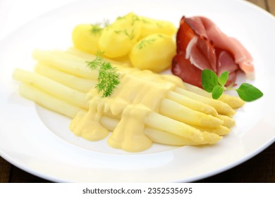 White asparagus, ham and potatoes on white plate, closeup. - Powered by Shutterstock