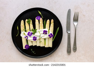 White Asparagus With Sauce, Wild Garlic, And Edible Flowers. Seasonal German Dish, Easter Food.