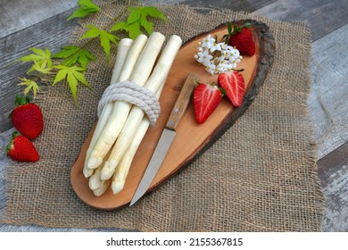 White Asparagus With Strawberries On A Wooden Disc.