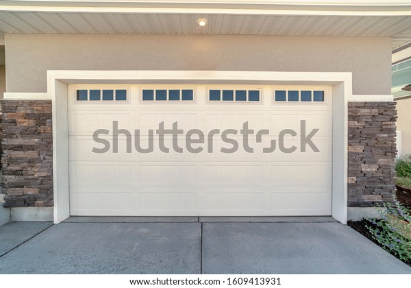 White automatic garage\
door for two cars